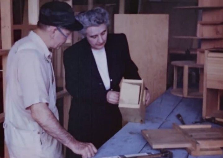 USDA specialist Lenore Sater confers with colleague on design of a kitchen shelf